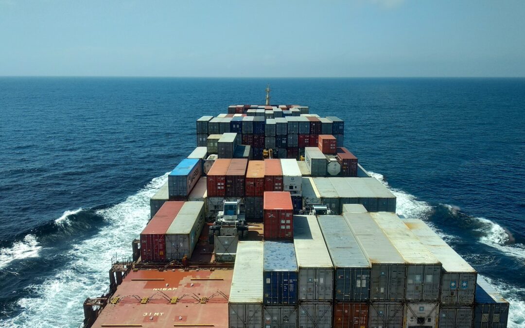 red and white cargo ship on sea during daytime