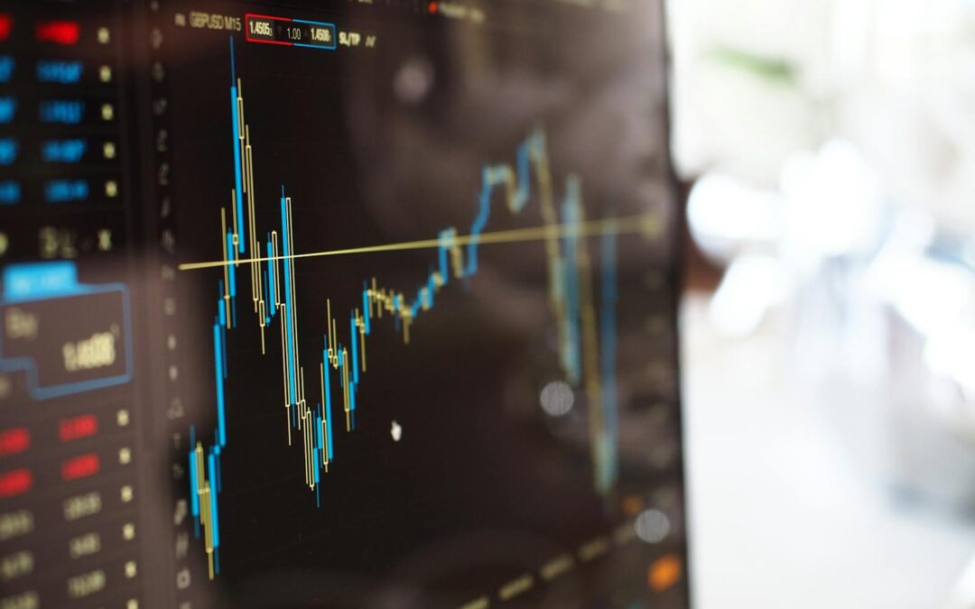 Detailed view of financial trading graphs on a monitor, illustrating stock market trends.